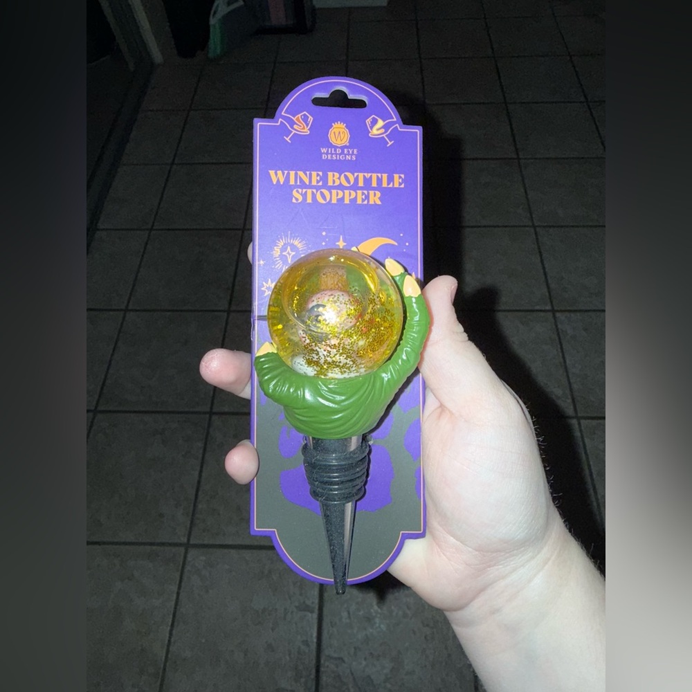Eye with Hand and Glittering Wine Bottle Stopper